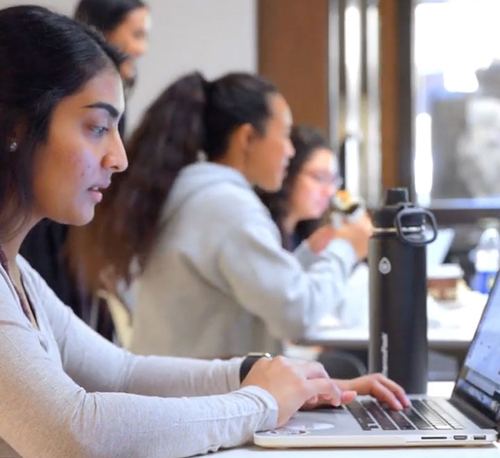 ֱ University of California student working on laptop computer